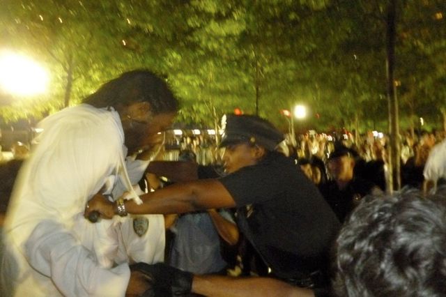 Councilmember Jumaane Williams and an NYPD officer at Zuccotti Park last night.